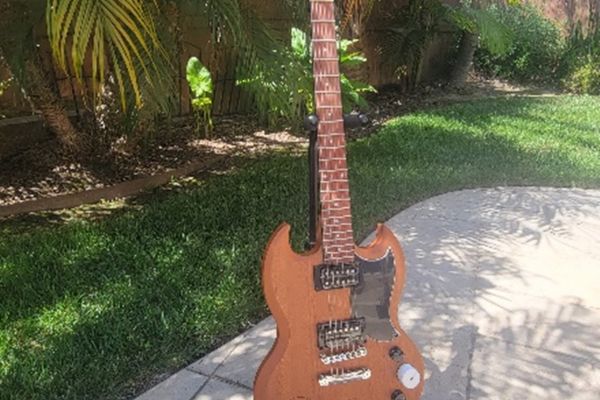 Golfer with Prosethetic Leg posing mid-swing with friend